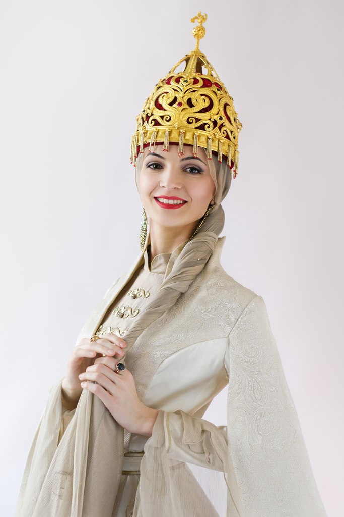 Circassian woman in traditional golden headdress and ceremonial Adyghe dress